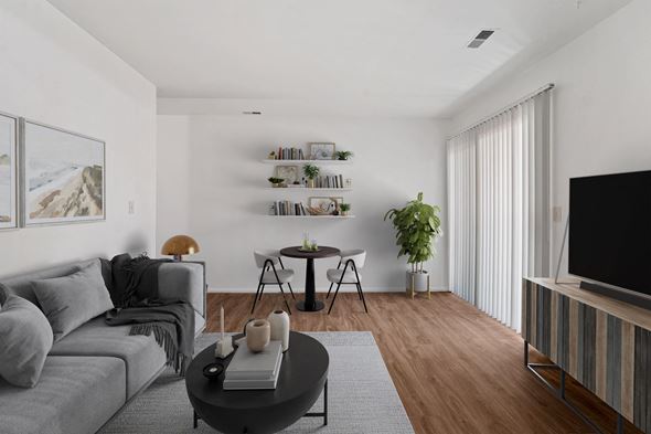 Sandy apartment for rent - a living room with white walls and hardwood floors