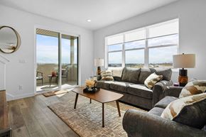 Lehi townhouse for rent - a living room with a couch and a table     and a balcony