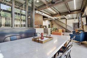 Logan apartment for rent - A dining room with a long table and chairs.