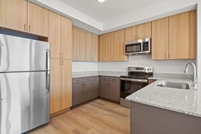 Salt Lake City apartment for rent - a kitchen with stainless steel appliances and granite counter tops at SPARK Apartments, Utah, 84116