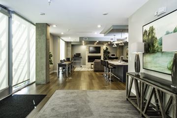 Salt Lake City apartment for rent - A modern living room with a grey rug and a television on a stand.