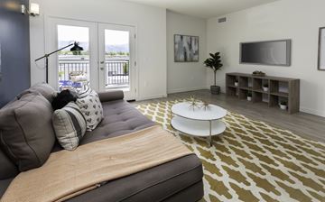 Salt Lake City apartment for rent - A living room with a grey couch and a white coffee table.
