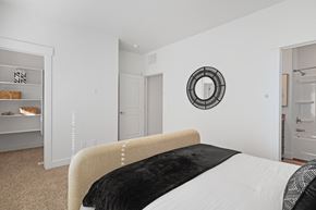Clearfield townhouse for rent - a bedroom with a large bed and a mirror on the wall
