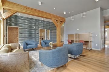 Ogden apartment for rent - A living room with a blue sofa and a wooden beam ceiling.
