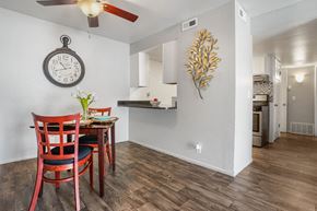 West Valley City apartment for rent - a dining area with a table and chairs and a clock on the wall