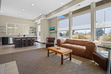 Provo apartment for rent - A living room with brown leather couches and a wooden coffee table.