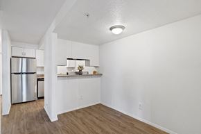 Park City apartment for rent - the living room and kitchen of an apartment with a stainless steel refrigerator