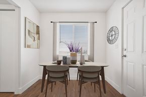 Tooele apartment for rent - a dining room with a table and chairs and a window