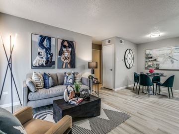 Dallas apartment for rent - A living room with a grey couch, a coffee table, and a painting on the wall.