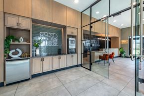 Burleson apartment for rent - A modern kitchen with wooden cabinets and a glass wall.
