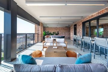 Burleson apartment for rent - A modern living room with a grey sofa and a wooden coffee table.