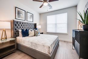 Little Elm apartment for rent - Bedroom with large window and neutral modern design, blinds, ceiling fans and more