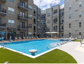Lewisville apartment for rent - A swimming pool in front of apartment buildings.