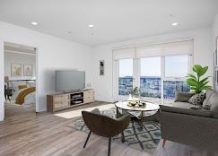 Los Angeles apartment for rent - A living room with a grey couch and a brown chair.