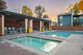 Claremont apartment for rent - A small pool with a diving board is surrounded by a brick wall.