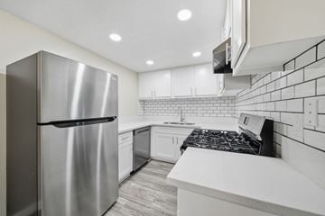 Escondido apartment for rent - A modern kitchen with a stainless steel refrigerator and white countertops.