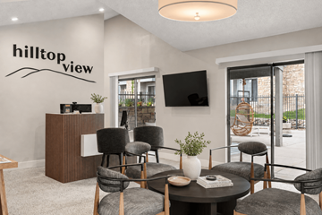 Denver apartment for rent - A living room with a black table and grey chairs.