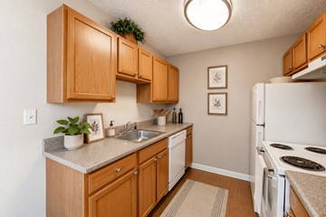 Denver apartment for rent - A kitchen with wooden cabinets and a white refrigerator.
