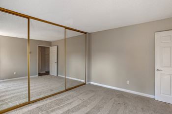 A bedroom with a large mirror