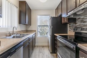 Canoga Park apartment for rent - Modern luxury meets comfort at Independence Plaza, where every home boasts a sleek, fully equipped kitchen featuring stainless steel appliances.