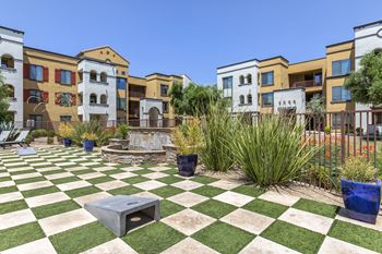 A green and white checkered picnic area in front of an apartment building