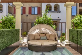 A curved seating area with a couch on a patio