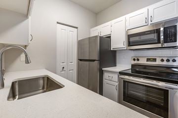 Phoenix apartment for rent - a kitchen with white cabinets and stainless steel appliances