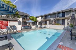 Canoga Park apartment for rent - Dive into luxury living at Independence Plaza, where every day feels like a vacation with our refreshing swimming pool and stylish patio retreat adorned with cozy umbrellas.