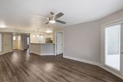 Phoenix apartment for rent - Step into our inviting living room adorned with sleek hardwood floors and complemented by a gentle ceiling fan breeze at Boulders at Lookout Mountain Apartment Homes, Phoenix, 85022