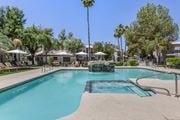 Phoenix apartment for rent - Mountain's pool oasis, complete with a stunning fountain and palm tree backdrop at Boulders at Lookout Mountain Apartment Homes, Phoenix, AZ 85022