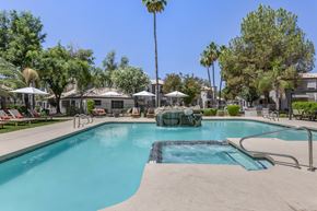 Phoenix apartment for rent - Mountain's pool oasis, complete with a stunning fountain and palm tree backdrop at Boulders at Lookout Mountain Apartment Homes, Phoenix, AZ 85022