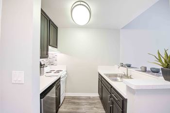 Gourmet kitchen with breakfast bar and pantry at cornerstone apartments, california, 91304