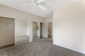 Roseville apartment for rent - Bedrooms at Ascent at the Galleria come with cozy carpeting and ceiling fans, providing comfort and a relaxing atmosphere in every home.