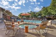 Santa Rosa apartment for rent - A pool area with chairs and umbrellas is shown.