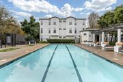 Santa Rosa apartment for rent - A large white building with a pool in front.