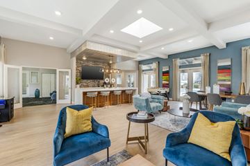 Chino Hills apartment for rent - A living room with blue chairs and a television.