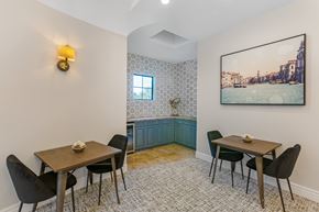 Chandler apartment for rent - A dining room with a table set for two and a view of a cityscape through the window.