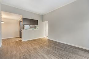 Simi Valley apartment for rent - an empty living room with wood flooring and a kitchen