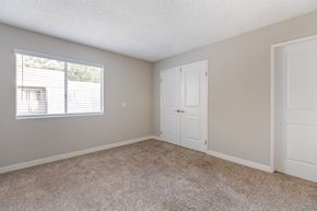 Simi Valley apartment for rent - an empty bedroom with white doors and a window