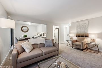 Kirkland apartment for rent - a living room with a couch and a chair and a bedroom