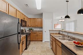 Indianapolis apartment for rent - Kitchen with wood cabinets at Aspen Lakes Apartments, Indianapolis, 46217
