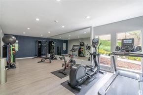 Bellevue apartment for rent - A spacious gym with a variety of equipment including treadmills, elliptical machines, and weight machines. at Kelsey Ridge, Bellevue, WA