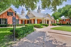Dallas apartment for rent - Exterior view of leasing office with green lawn at SaddleBrook Apartments, Dallas, TX, 75248