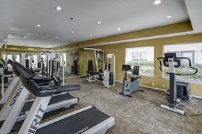 Dallas apartment for rent - A gym with treadmills, weights, and exercise machines.