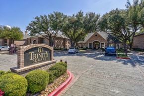 Dallas apartment for rent - A sign that says Trinity Square is in front of a building.