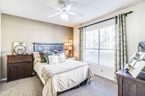 Frisco apartment for rent - Well-lit bedroom with huge window, green curtains, beige at Cypress Lake at Stonebriar Apartments, Texas, 75034