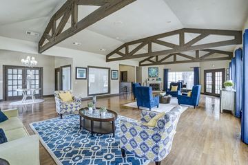 Dallas apartment for rent - A spacious living room with a blue and white patterned rug on the floor.
