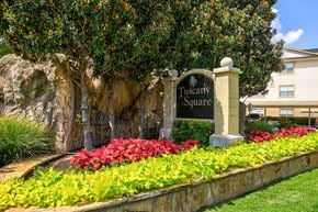Dallas apartment for rent - A sign that says Tuscany Square stands in front of a building.