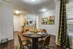 Irving apartment for rent - A dining room with a table set for two and a painting on the wall.