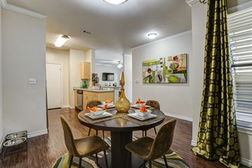 Irving apartment for rent - A dining room with a table set for two and a painting on the wall.